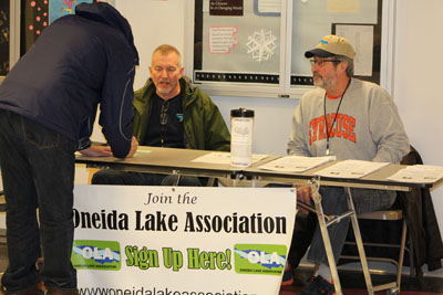 Oneida Lake Association Membership Sign up Join the Oneida Lake Association signup table with members sitting at the table signing up new members